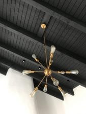  sputnik light component hanging from a black ceiling